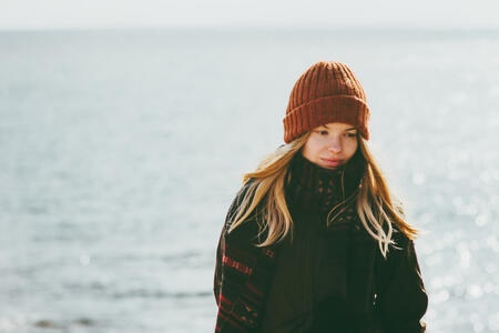 Woman walking at winter beach cold sea outdoor seasonal melancholy Lifestyle concept