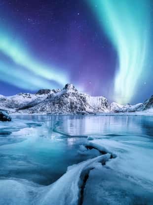 Aurora Borealis, Lofoten islands, Norway. Nothen light, mountains and frozen ocean. Winter landscape at the night time. Norway travel - image