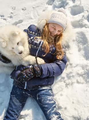 Dog breed Samoyed husky with girl outdoors. puppy dog for a walk with his owner