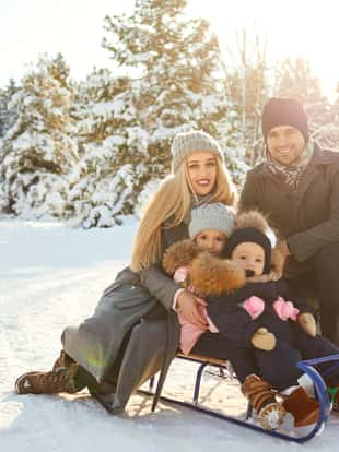 Happy family smiling in winter in a park
