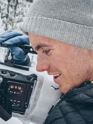He smiles as he looks into the view finder display