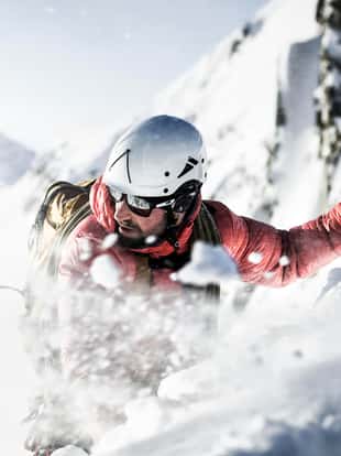 Close up of a mountain climber with strong wind in the Austrian Alps.
