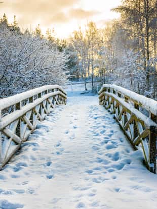 Snowy, wooden bridge in a winter day. Stare Juchy, Poland