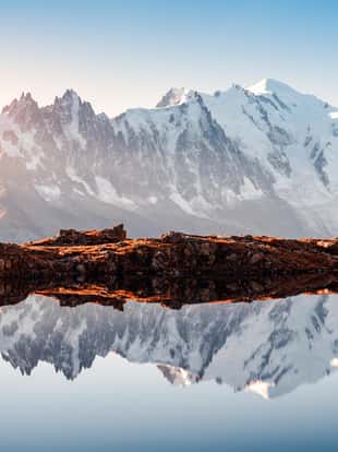 Incredible view of clear water and sky reflection on Chesery lake (Lac De Cheserys) in France Alps. Monte Bianco mountains range on background. Landscape photography, Chamonix.
