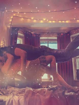 Young couple flying above the bed