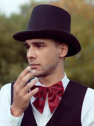 Young gentleman with  hat smoking cigarette