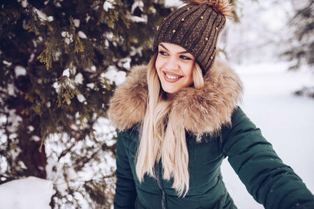 Beautiful young girl enjoying snowfall