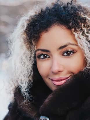 Beauty portrait of young african american woman in winter park