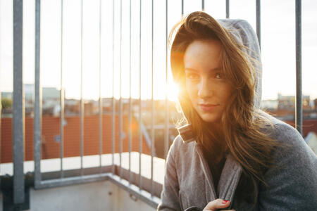 young woman portrait in urban scene with backlit