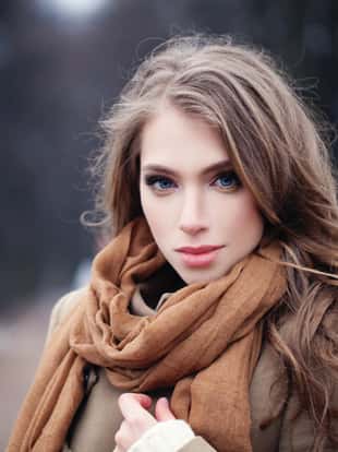 Nice young woman outdoors in park. Perfect female face