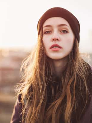 Portrait of a serious hipster girl at sunset