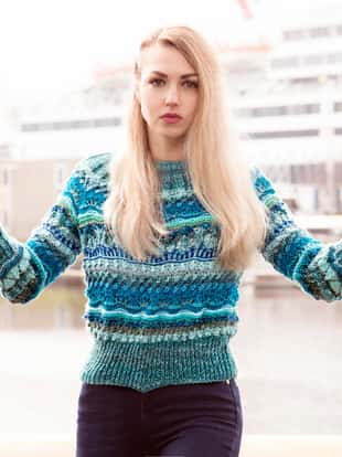 Woman posing in a fashionable knitted blue sweater