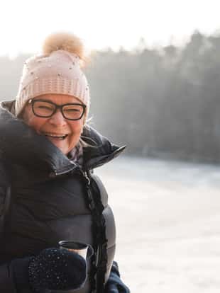 Active seniors on a walk through the beautiful Swedish landscapes in winter.