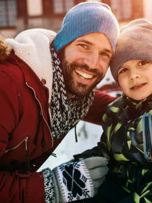 Portrait of father and his son outdoor at wintertime.