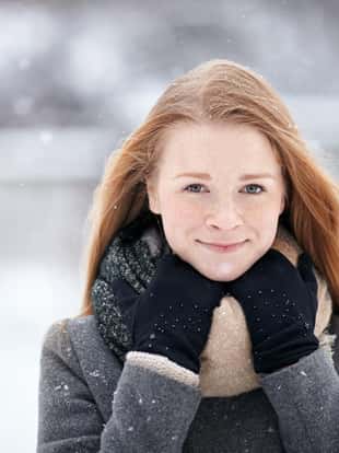 Beauty portrait natural looking young adorable redhead girl wearing knitted scarf grey coat on blurred winter background