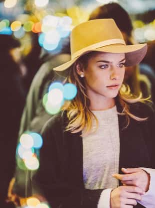 Young woman visiting the Christmas market at evening