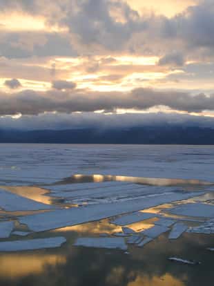 The suns sets over Lake Baikal, Siberia, Russia. Taken from Olkhon Island in June 2013, the lake is still thawing after a hard Siberian winter.