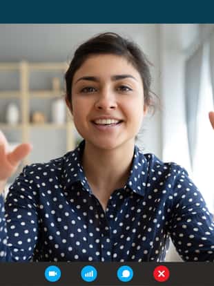 Headshot portrait screen view of smiling young Indian woman sit at home talk on video call with friend or relative, happy millennial biracial female speak online using Webcam conference on computer