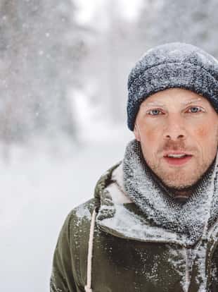 Man out in nature during snowy day in winter