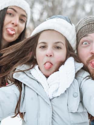 Smiling Family Taking Selfie With Tongues Out