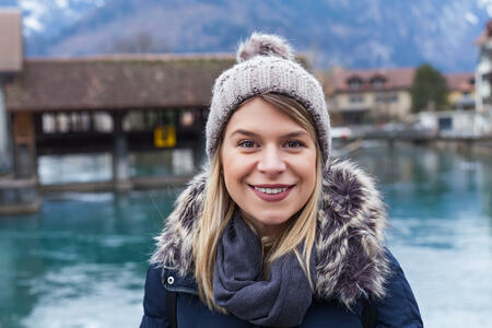 Portrait of an attractive young woman smiling at the camera in Interlaken, Switzerland, swiss alps