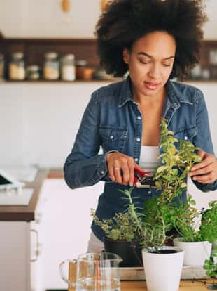 Beautiful mixed race woman gardening.