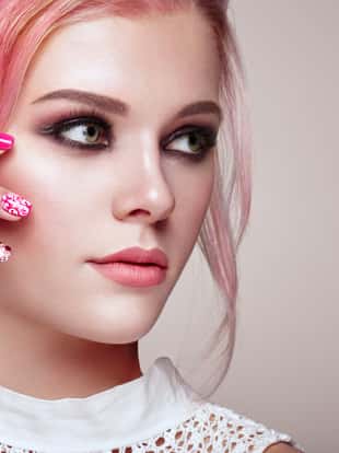 Blonde Girl with Elegant and shiny Hairstyle. Beautiful Model Woman with Curly Hairstyle. Care and Beauty Hair products. Nails and Manicure