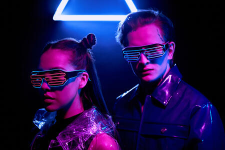 Young couple in LED goggles