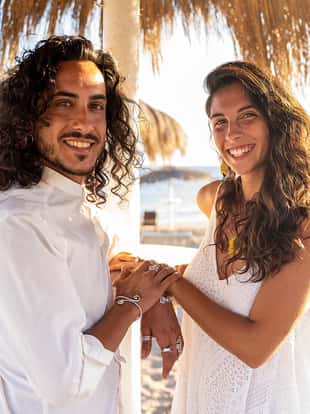 Happy beautiful latino couple spending time together on the tropical beach. Boho wedding. Real people emotions. Love. Summer time.