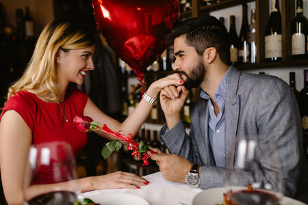 Beautiful young romantic couple dating at night in restaurant.