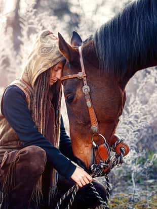 Portrait woman and horse outdoors. Woman hugging a horse