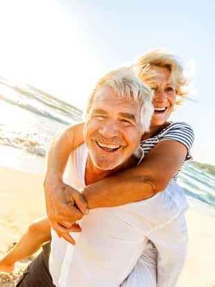 Smiling senior couple enjoying their retirement on the beach
