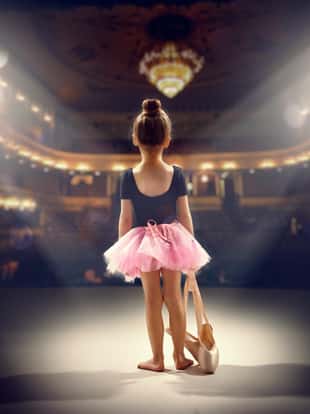 little girl plays in the ballet