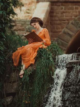 The beautiful countess in a long orange dress sits near a source of water and reading a book, elf, Princess in vintage dress, the queen of the forest,fashionable toning creative computer colors