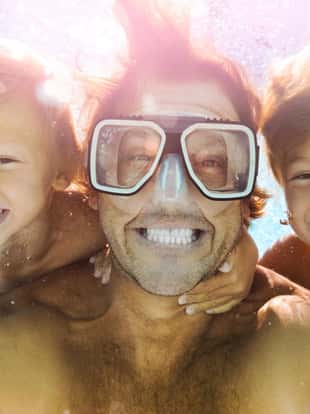 Dad and Sons Having Fun Doing A Selfie Underwater