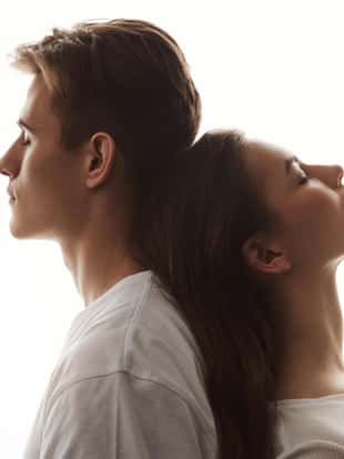 Photo of man and woman in love. She lays her head on his back with eyes closed. Maybe they sometimes have fights but they still feel affection like it was the first time they met. Emotions concept
