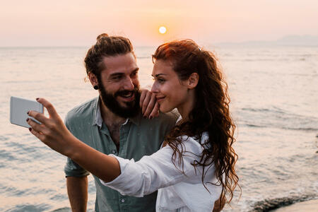 Young couple taking a selfie at the beach