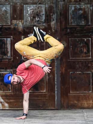 Male breakdancer dancing. About 25 years old Caucasian man.
