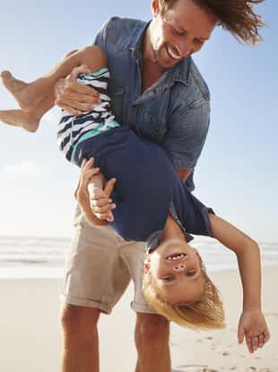 Father Having Fun With Son On Summer Beach Vacation