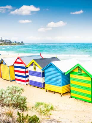 Beautiful Bathing houses on white sandy beach at Brighton beach in Melbourne, Australia.