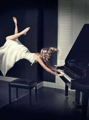 Girl levitating while playing piano