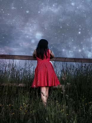 Woman in red dress watching the stars