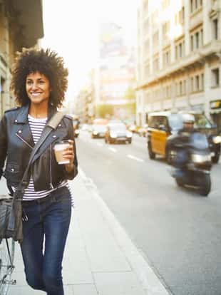 Young hipster woman in the streets of Barcelona commuting. Mixed race model, spanish and Ethiopian.