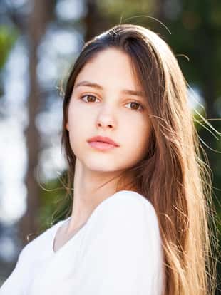 Close up portrait brunette girl in summer park background