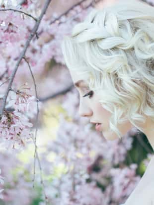 Beautiful girl on the background of spring bush