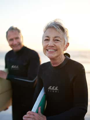 Cropped shot of a senior married couple coming from surfing