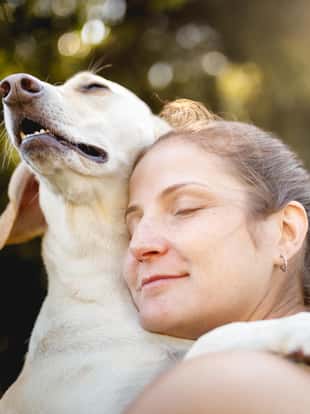 Woman hugging her dog.